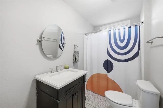 a bathroom with a sink a mirror a toilet and a mirror