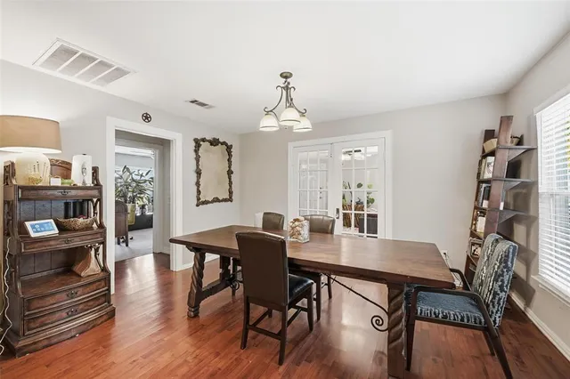 a view of a dining room with furniture wooden floor and a chandelier