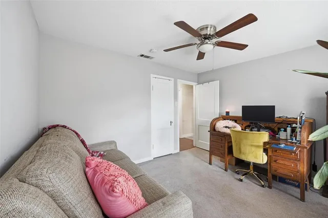 a workspace with furniture and ceiling fan