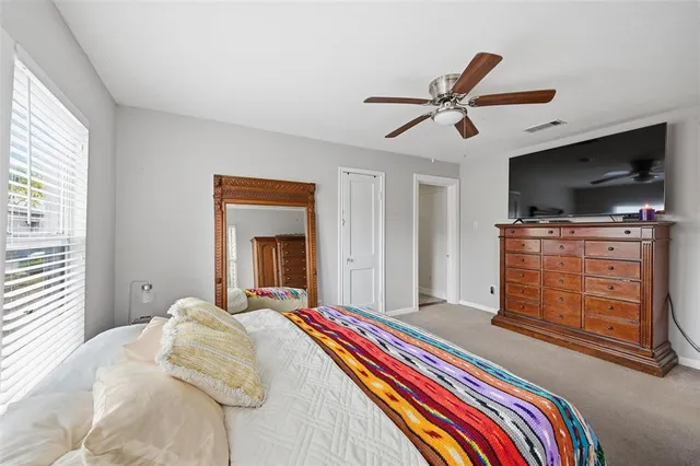 a bedroom with a bed and flat screen tv