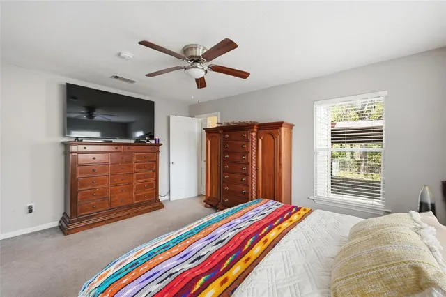 a bedroom with a bed and flat screen tv