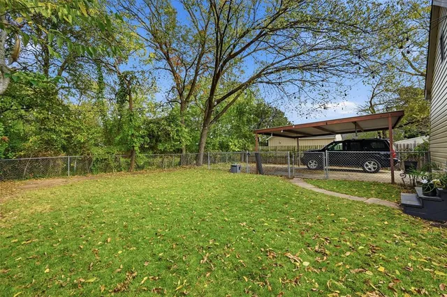 a view of a backyard with sitting area