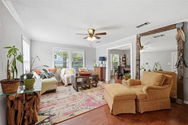a living room with furniture ceiling fan and a window