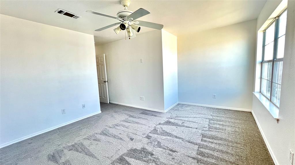 4503 Fortuna Street Fort Worth, TX 76119 - Photo 14 of 26 a view of room with window and ceiling fan