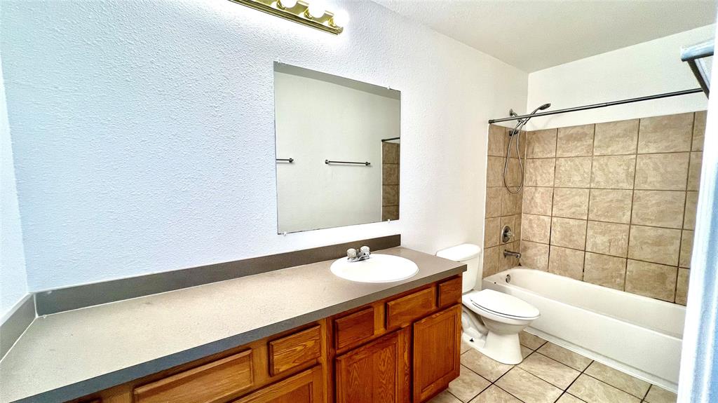 4503 Fortuna Street Fort Worth, TX 76119 - Photo 15 of 26 a bathroom with a sink a toilet and shower