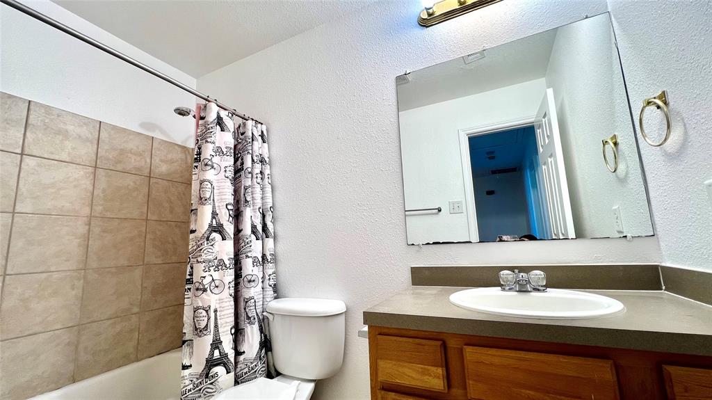 4503 Fortuna Street Fort Worth, TX 76119 - Photo 20 of 26 a bathroom with a sink and a mirror