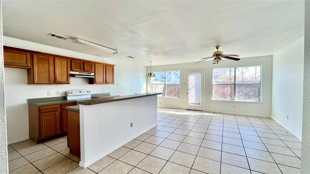 4503 Fortuna Street Fort Worth, TX 76119 - Photo 2 of 26 a kitchen with stainless steel appliances granite countertop a stove a sink and a refrigerator