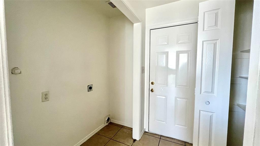 4503 Fortuna Street Fort Worth, TX 76119 - Photo 23 of 26 a bathroom with a glass shower door