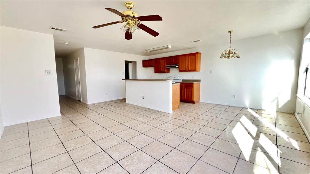 4503 Fortuna Street Fort Worth, TX 76119 - Photo 3 of 26 a view of a livingroom with a furniture a ceiling fan and window