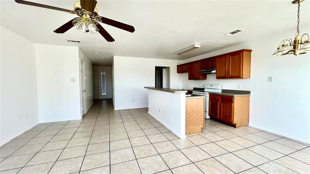 4503 Fortuna Street Fort Worth, TX 76119 - Photo 4 of 26 a kitchen with stainless steel appliances a refrigerator sink and microwave