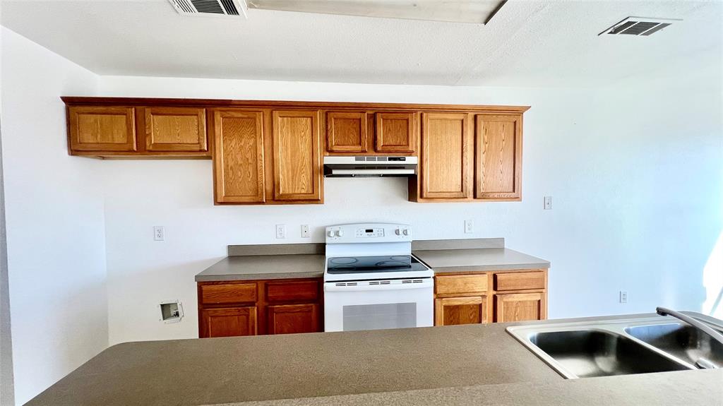 4503 Fortuna Street Fort Worth, TX 76119 - Photo 6 of 26 a kitchen with stainless steel appliances granite countertop a stove and a sink