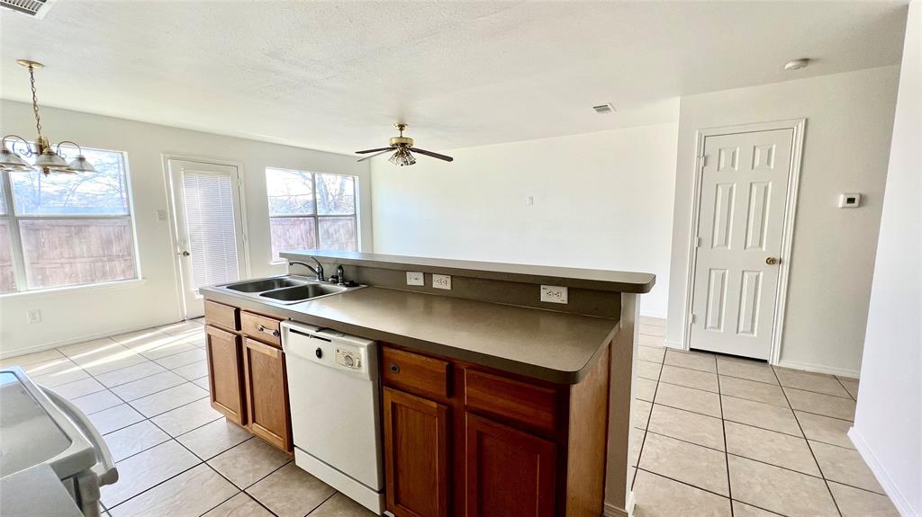 4503 Fortuna Street Fort Worth, TX 76119 - Photo 7 of 26 a kitchen with stainless steel appliances granite countertop a sink and a stove