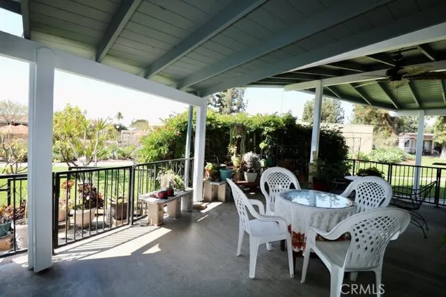 a view of a patio with a table chairs and a grill