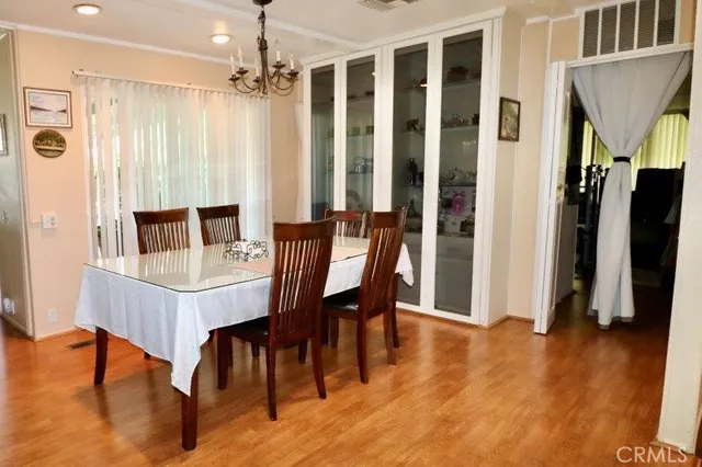 a dining room with furniture window and wooden floor