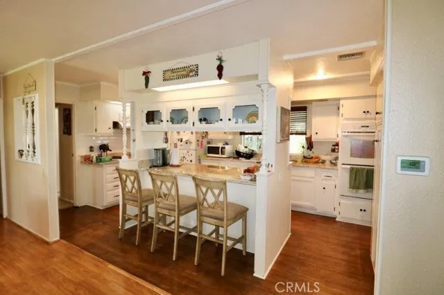 a kitchen with stainless steel appliances a refrigerator and cabinets