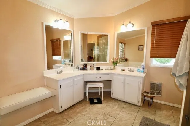 a bathroom with a sink vanity and mirror