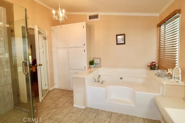 a bathroom with a tub a sink and a shower