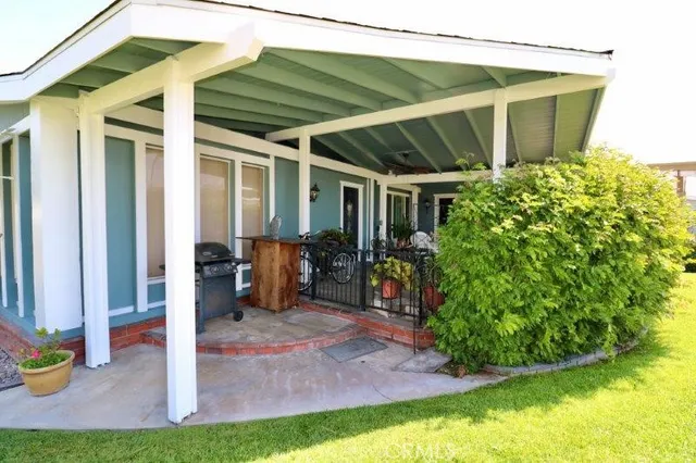 a view of a backyard with table and chairs under an umbrella