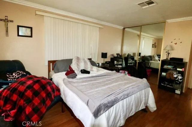 a bedroom with bed and a closet