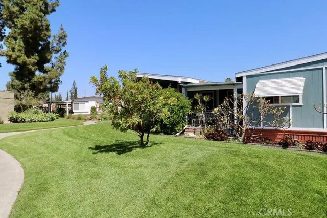 a view of a house with a backyard