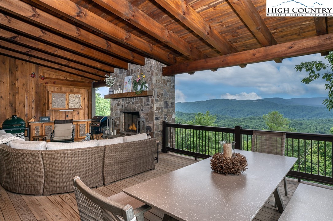 550 Pepperroot Road Boone, NC 28607 - Photo 12 of 50 a view of a roof deck with couches chairs and wooden floor