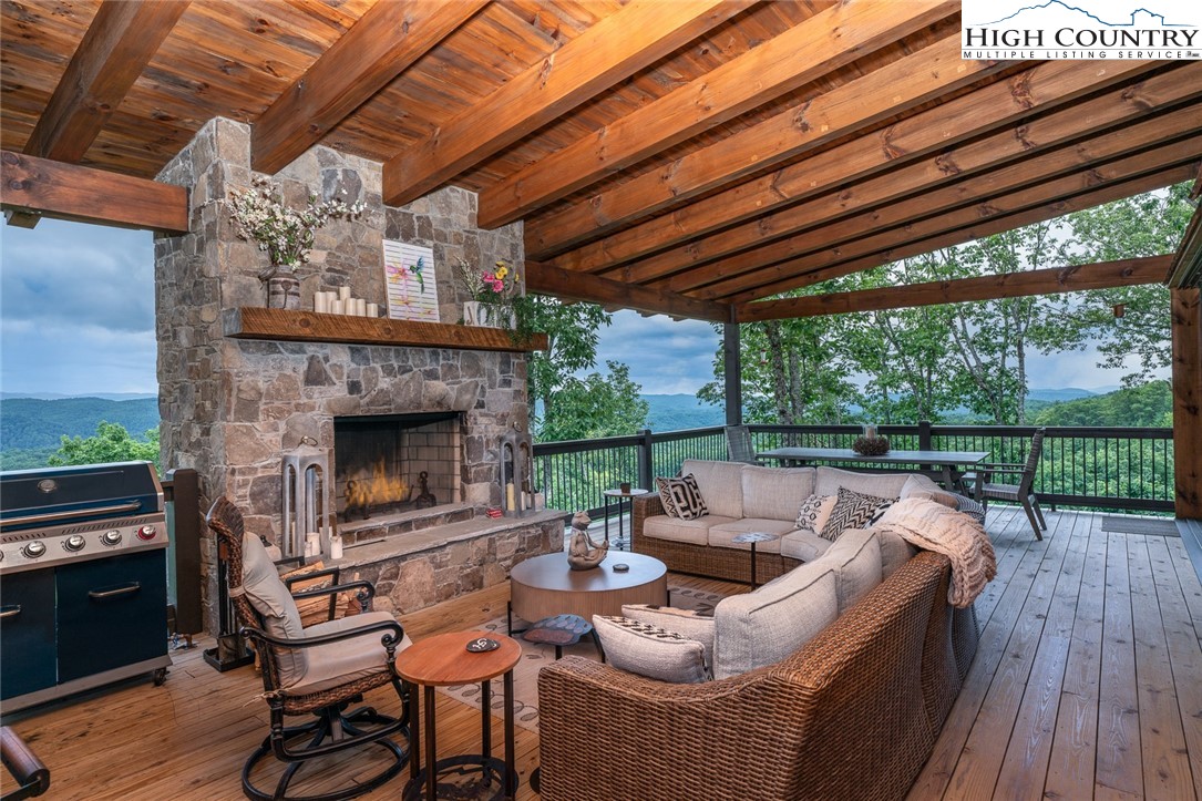 550 Pepperroot Road Boone, NC 28607 - Photo 13 of 50 a patio with patio fireplace and wooden floor
