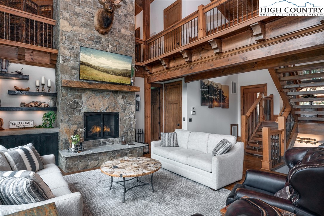 550 Pepperroot Road Boone, NC 28607 - Photo 21 of 50 a living room with furniture a rug and a fireplace