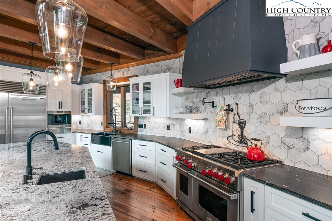 550 Pepperroot Road Boone, NC 28607 - Photo 22 of 50 a kitchen with granite countertop a sink stainless steel appliances and cabinets