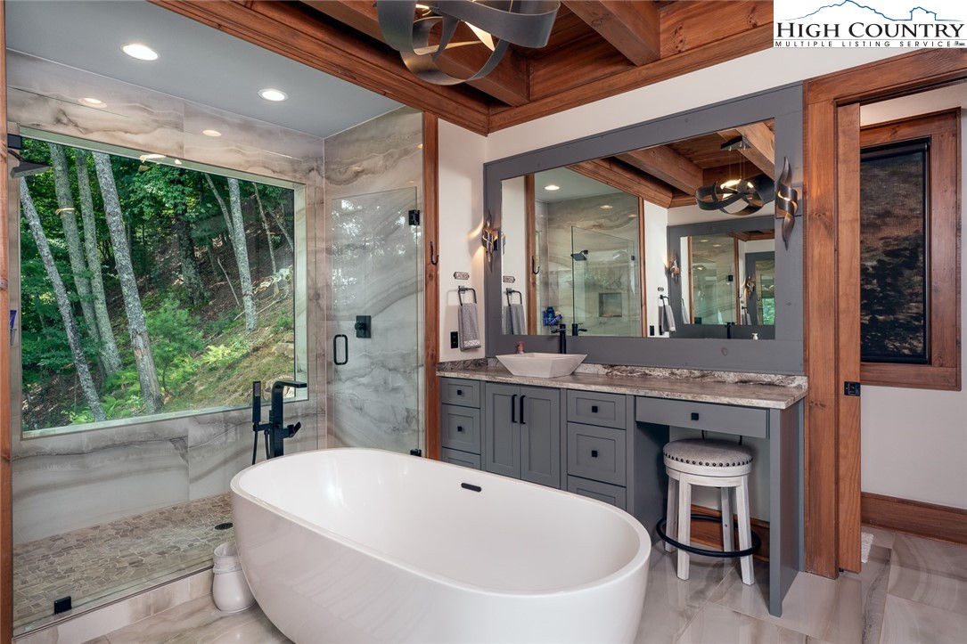 550 Pepperroot Road Boone, NC 28607 - Photo 26 of 50 a spacious bathroom with a double vanity sink a large mirror and a bathtub