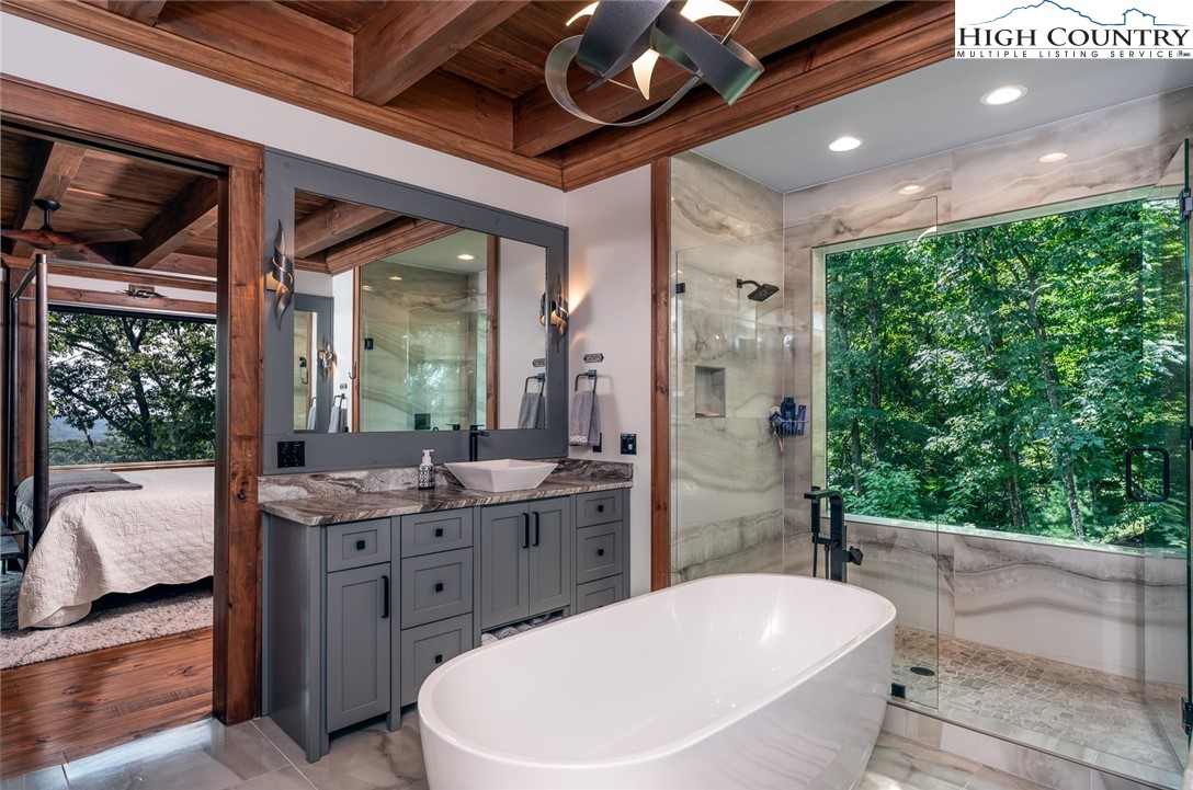 550 Pepperroot Road Boone, NC 28607 - Photo 27 of 50 a bathroom with a granite countertop sink toilet and shower
