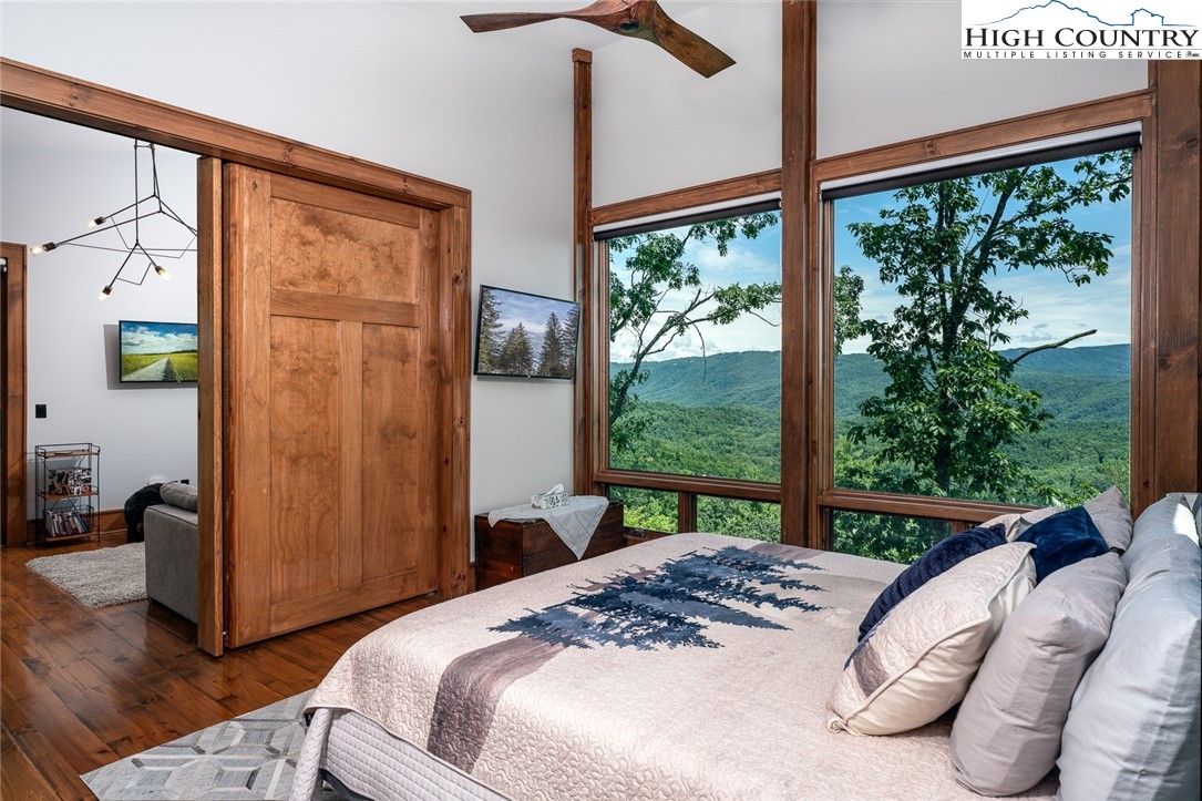 550 Pepperroot Road Boone, NC 28607 - Photo 37 of 50 a bedroom with a bed and a large window with outer view