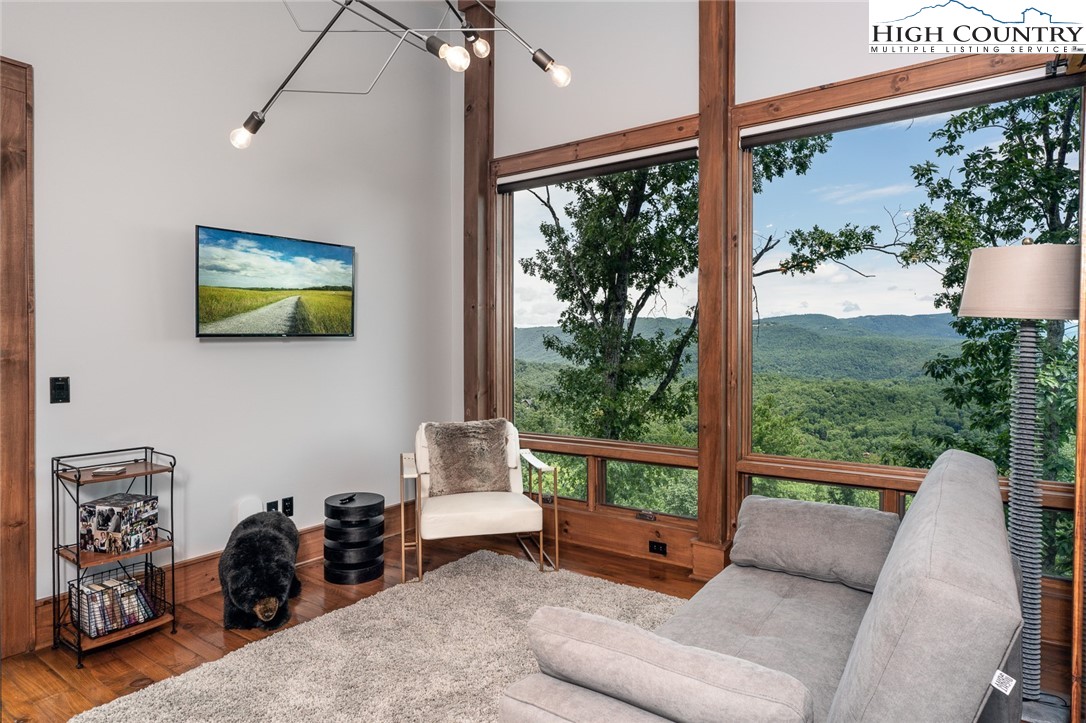 550 Pepperroot Road Boone, NC 28607 - Photo 39 of 50 a living room with furniture and a floor to ceiling window