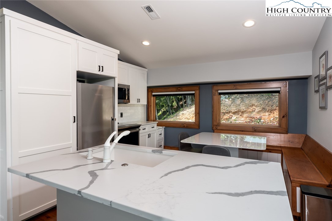 550 Pepperroot Road Boone, NC 28607 - Photo 40 of 50 a bedroom with a large bed and a flat tv screen on dresser