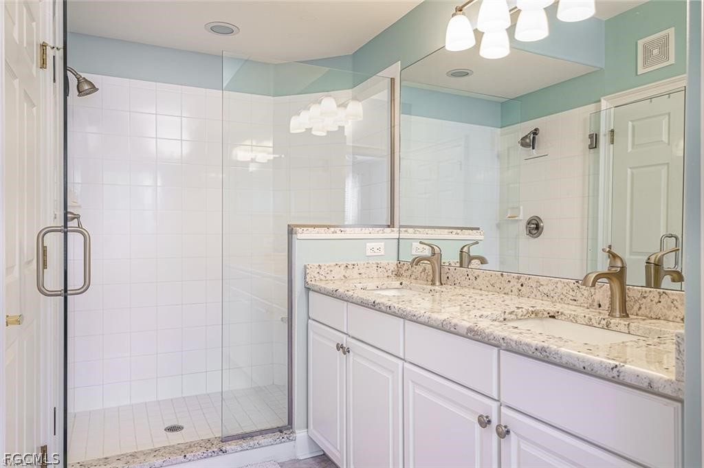 9667 Hemingway Lane, Unit 3107 Fort Myers, FL 33913 - Photo 10 of 23 a bathroom with a granite countertop sink shower and a mirror