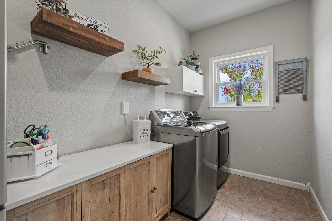 323 Patricia Road Georgetown, TX 78628 - Photo 17 of 40 a kitchen with stainless steel appliances a sink a stove and a window