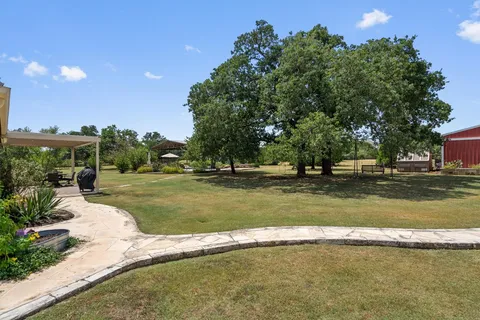 a view of a swimming pool with a patio and a garden