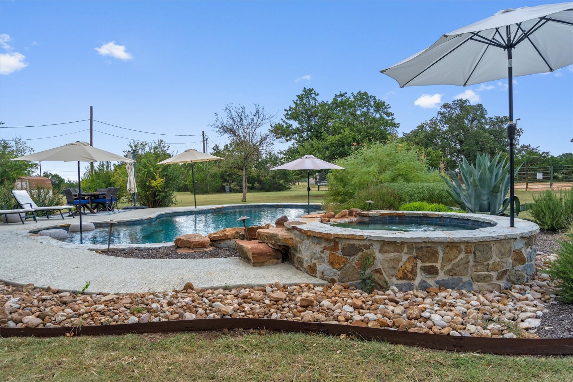 323 Patricia Road Georgetown, TX 78628 - Photo 21 of 40 a view of a swimming pool with a patio and a garden