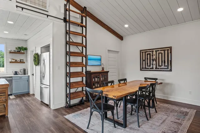 a kitchen with a refrigerator a sink and cabinets