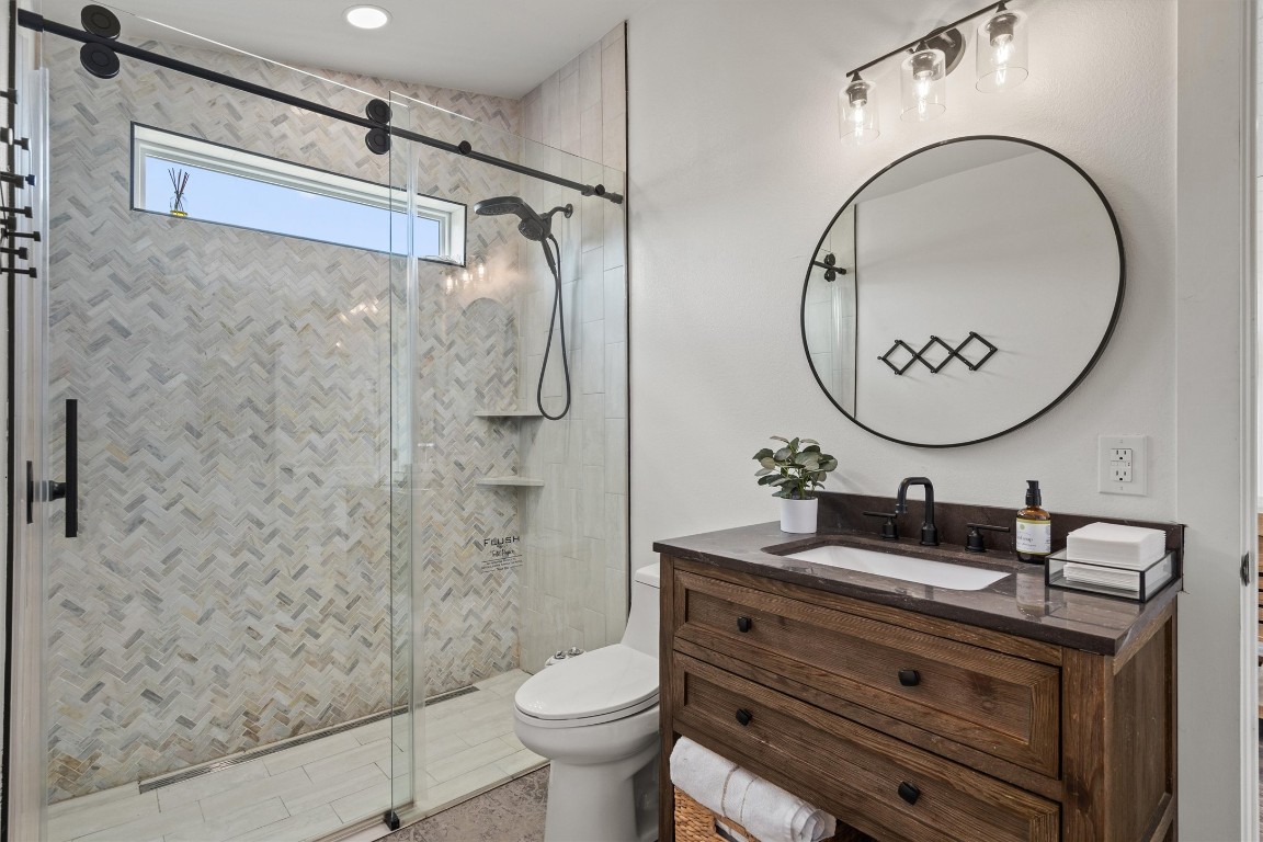 323 Patricia Road Georgetown, TX 78628 - Photo 28 of 40 a bathroom with a sink mirror toilet and shower