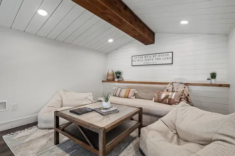 an aerial view of a house with outdoor space and lake view in back