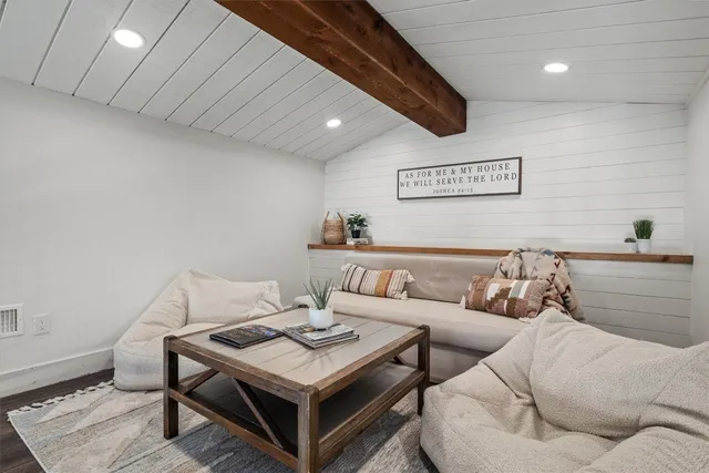 an aerial view of a house with outdoor space and lake view in back