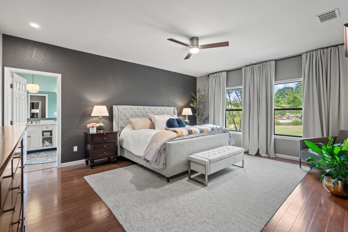 323 Patricia Road Georgetown, TX 78628 - Photo 8 of 40 a bedroom with a large bed and a chandelier