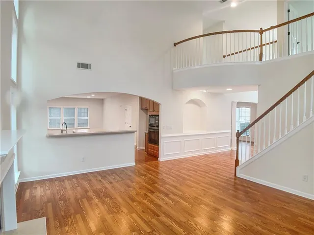 a view of staircase with white walls and wooden floor