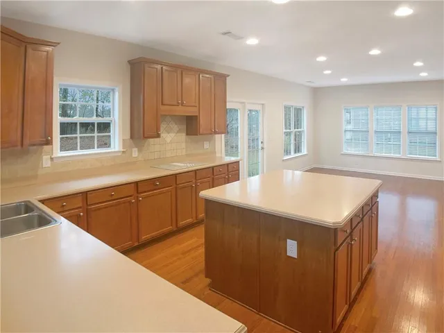 a kitchen with stainless steel appliances granite countertop a sink a stove and a refrigerator