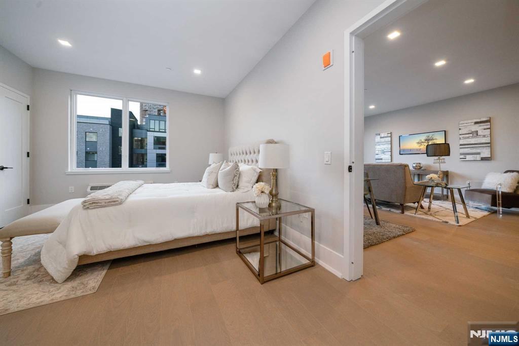 7101 River Road, Unit 304A North Bergen, NJ 07047 - Photo 14 of 24 a bedroom with furniture and a large window