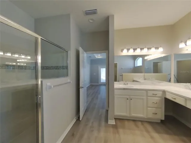 a bathroom with a double vanity sink and mirror