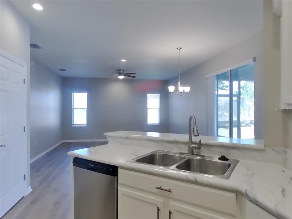 Undisclosed Address Zephyrhills, FL 33541 - Photo 2 of 21 a kitchen with a sink and chandelier