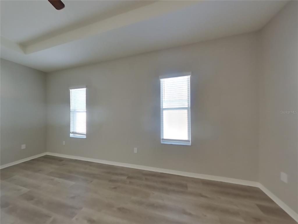 Undisclosed Address Zephyrhills, FL 33541 - Photo 8 of 21 an empty room with wooden closet and windows