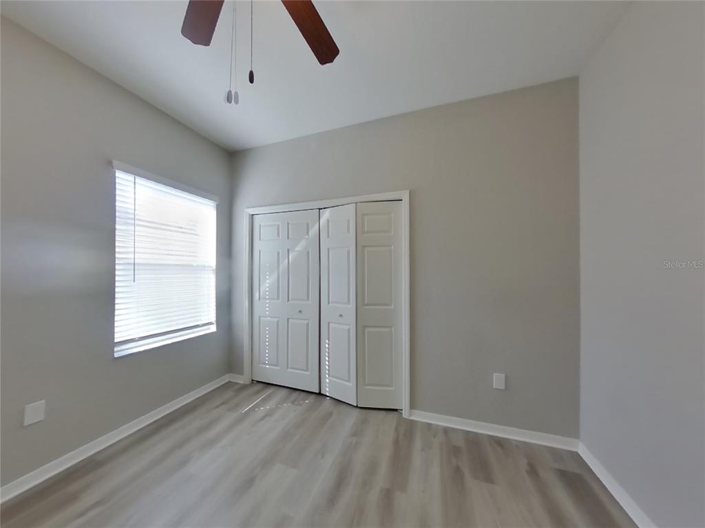 Undisclosed Address Zephyrhills, FL 33541 - Photo 9 of 21 wooden floor in an empty room with a window