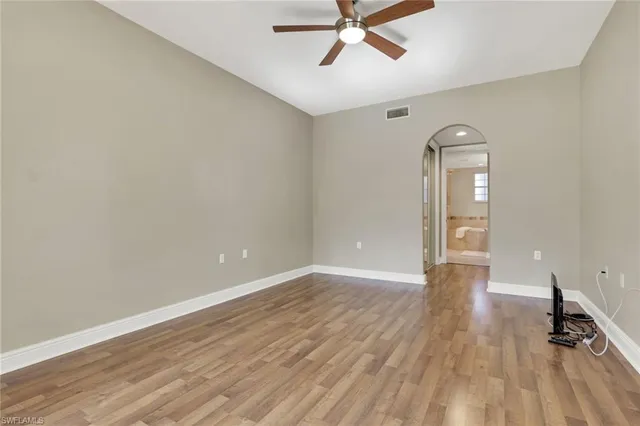 a view of a room with wooden floor and white walls